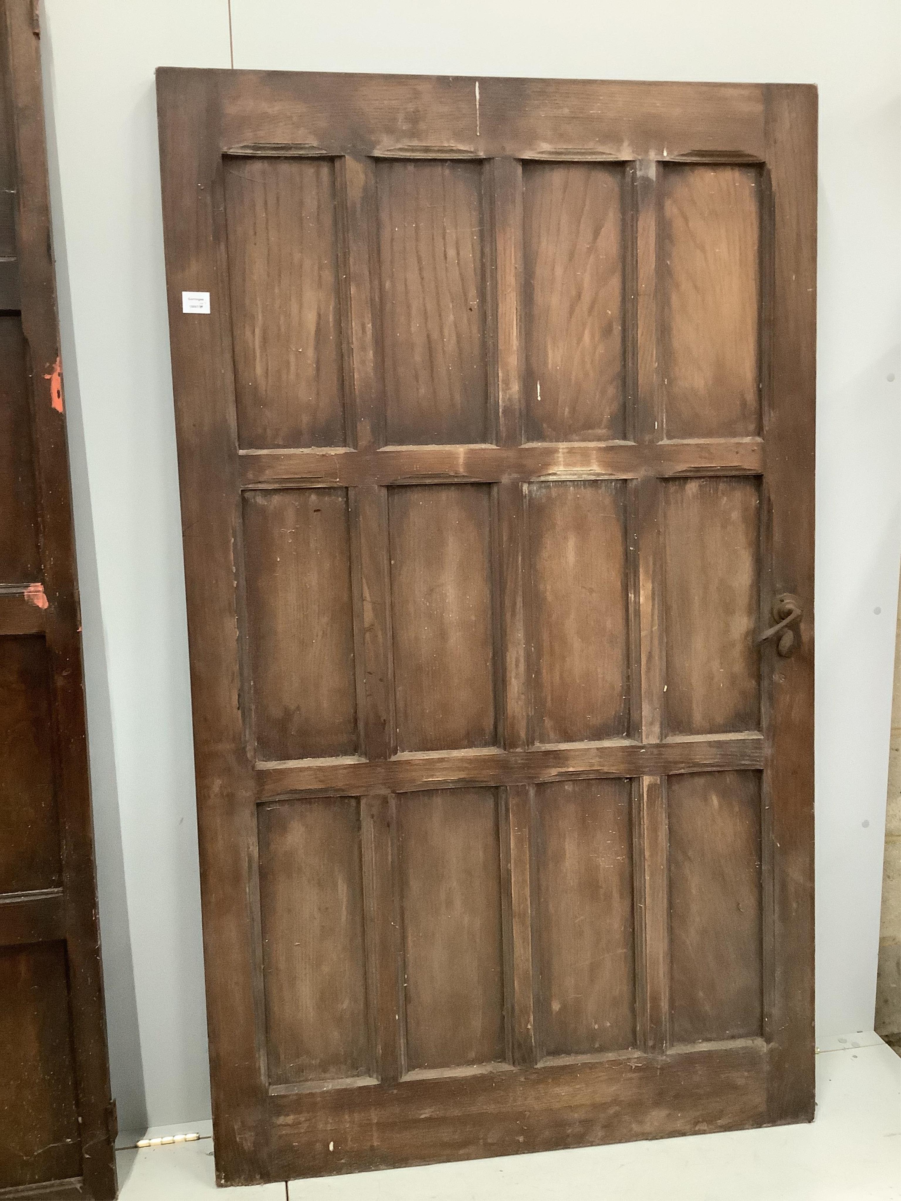 Three various panelled oak doors, largest width 107cm, height 181cm. Condition - poor to fair